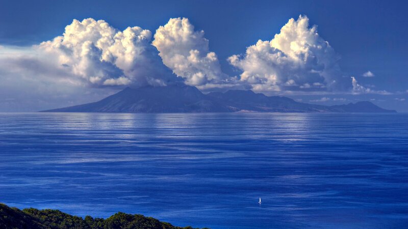 Volcanic Island in Ocean — Blue, Serene, Afternoon