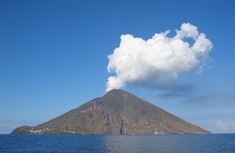 Volcanic island with smoke plume