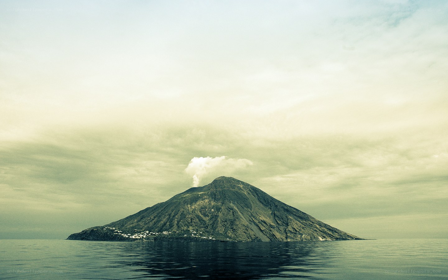 Volcanic island with smoke