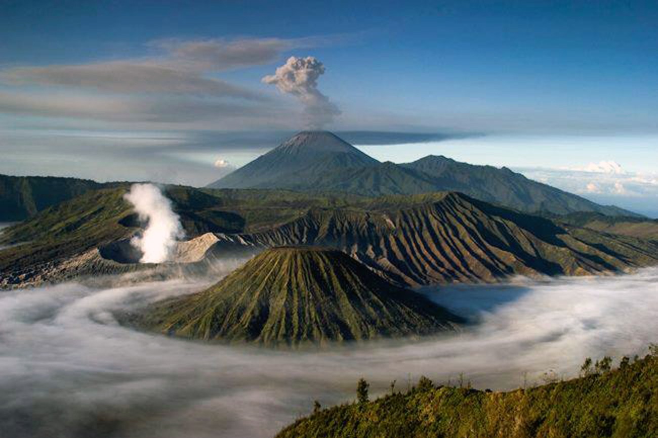 Volcanic landscape with erupting mountains