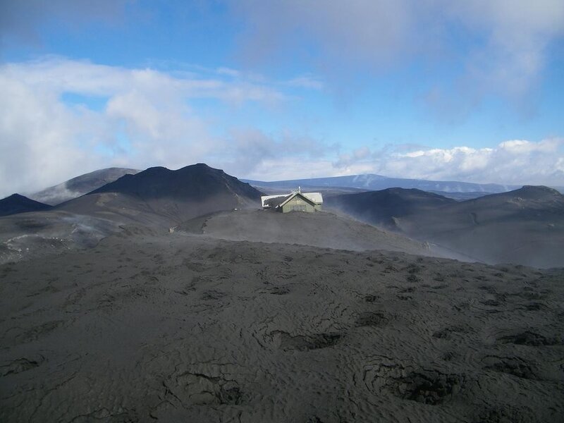 Volcanic landscape with small building