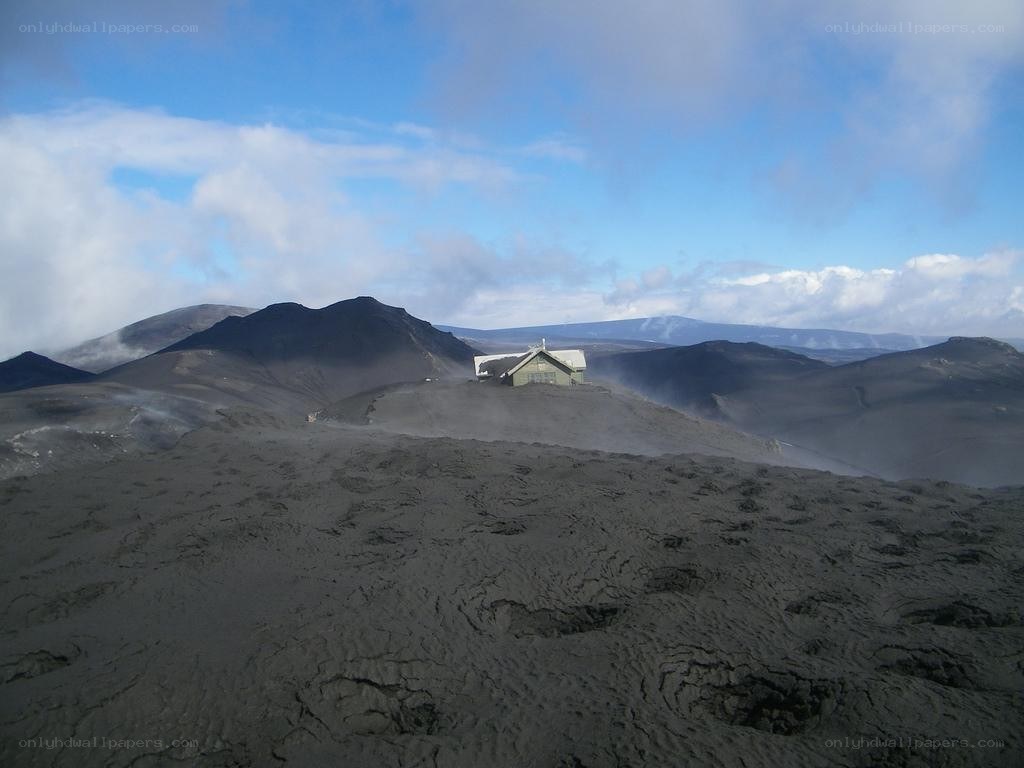 Volcanic landscape with small building