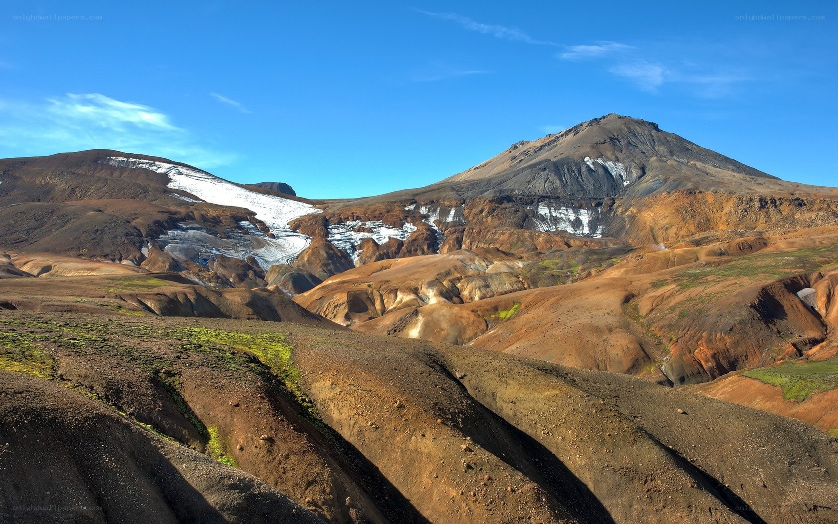 Volcanic landscape with snow patches