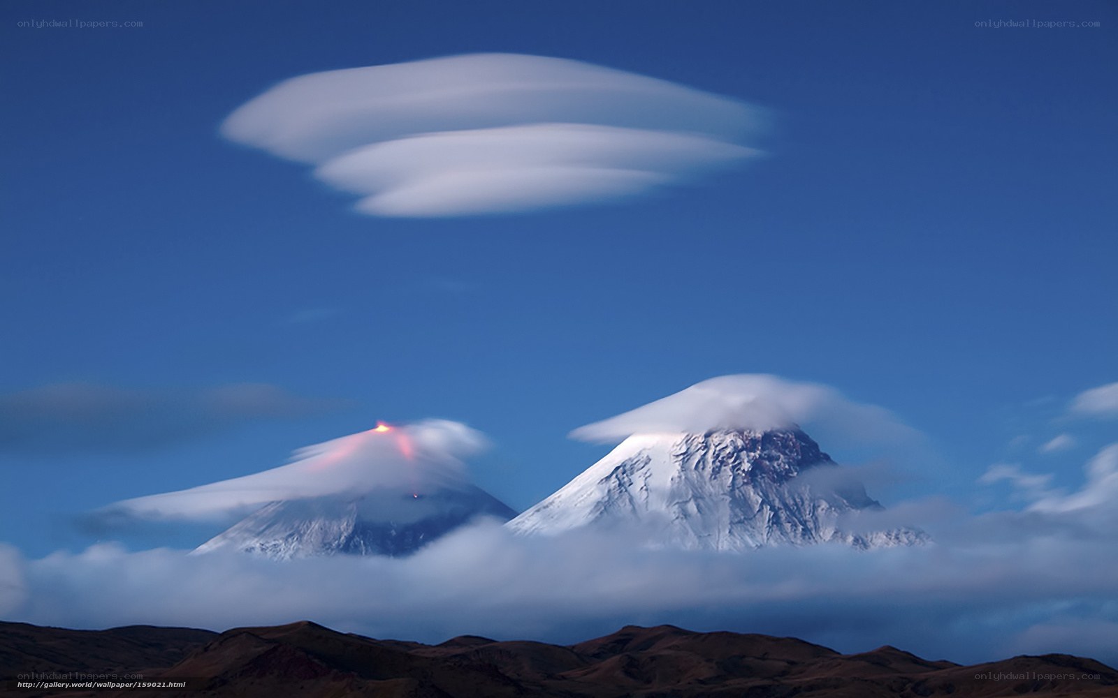 Volcanic peaks with lenticular clouds