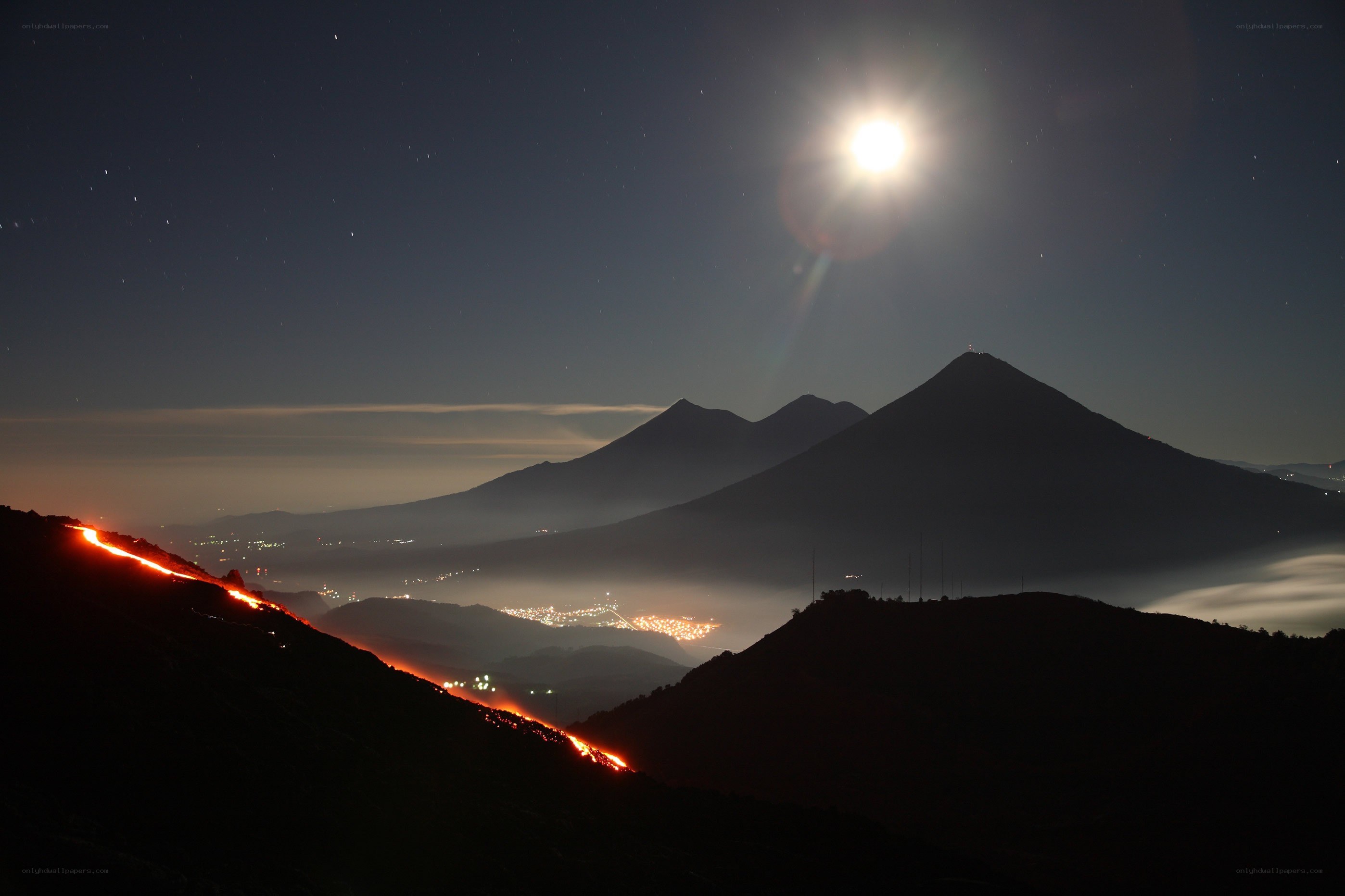 Volcano at night with moon