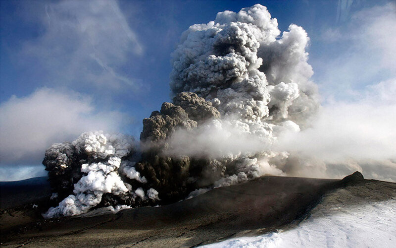 Volcano erupting ash plume