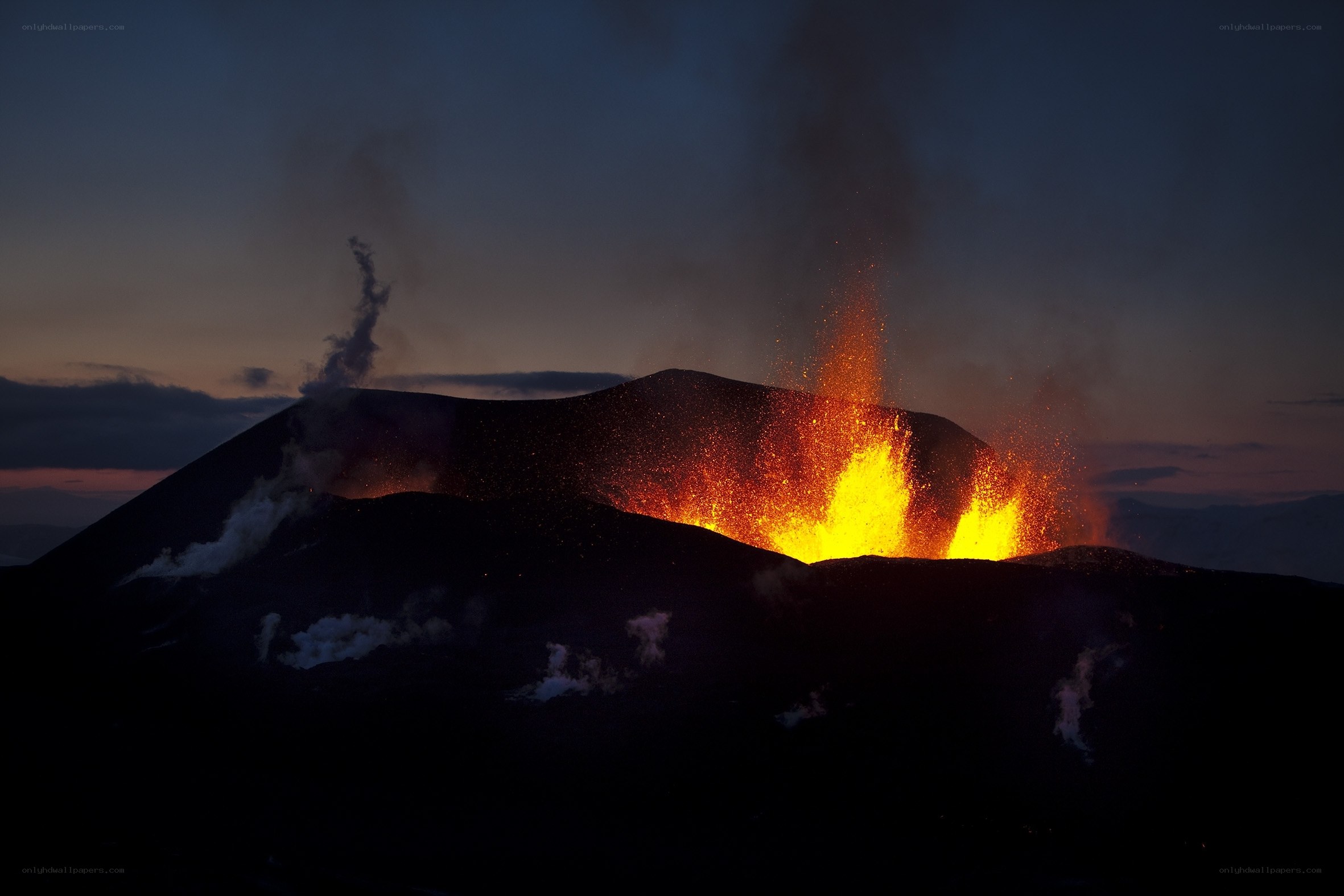 Volcano erupting at dusk