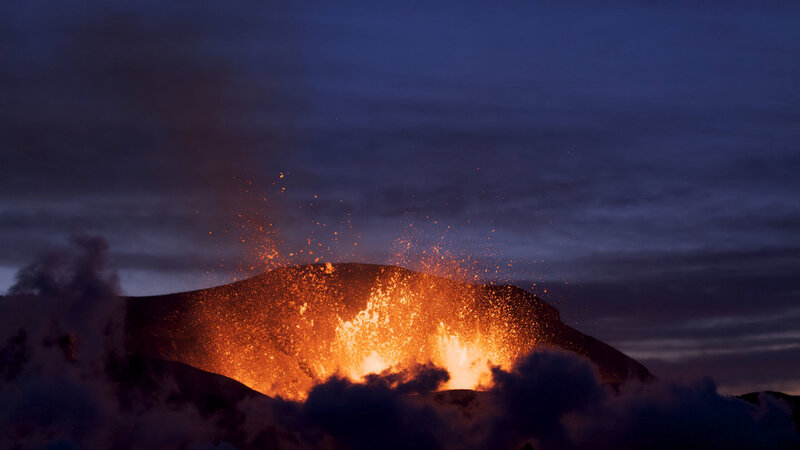 Volcano erupting at dusk