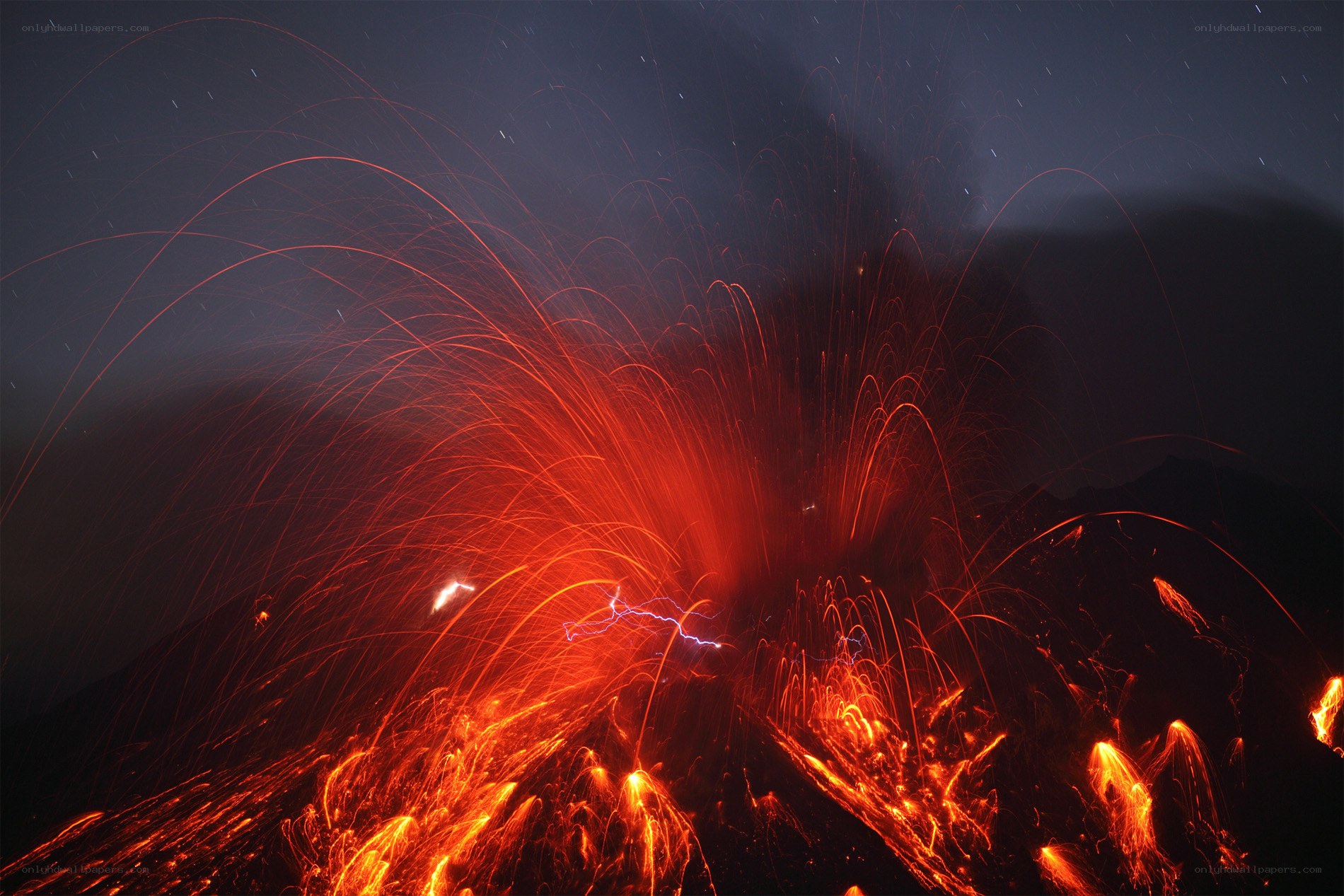 Volcano erupting at night