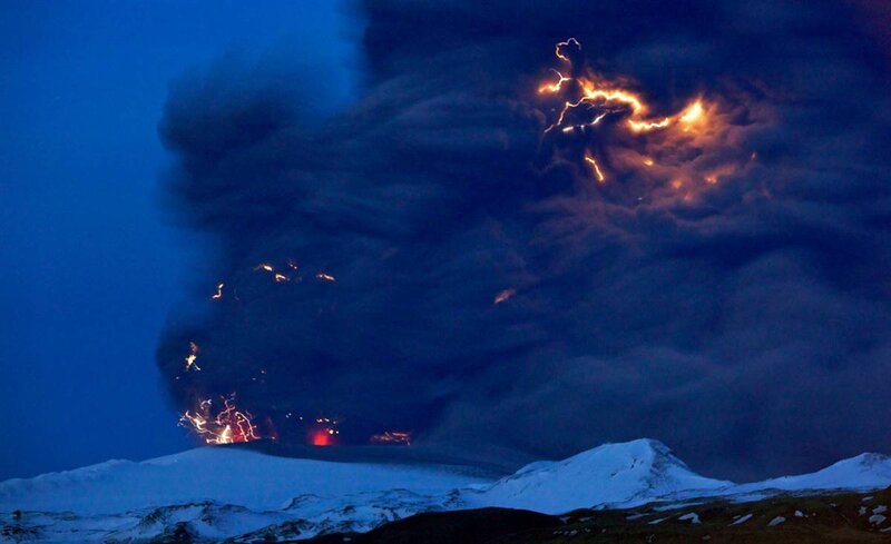 Volcano erupting at night