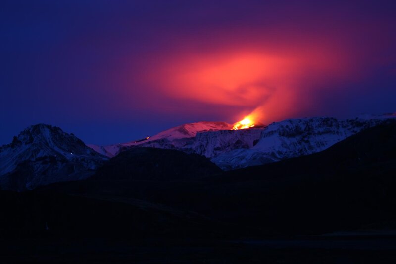 Volcano erupting at night