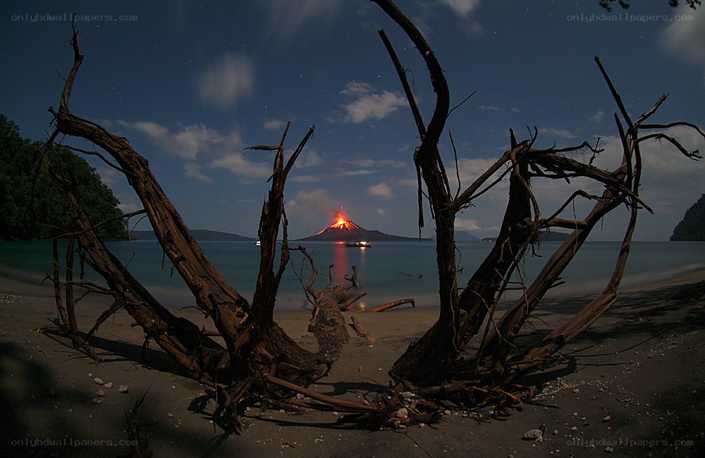 Volcano erupting at night