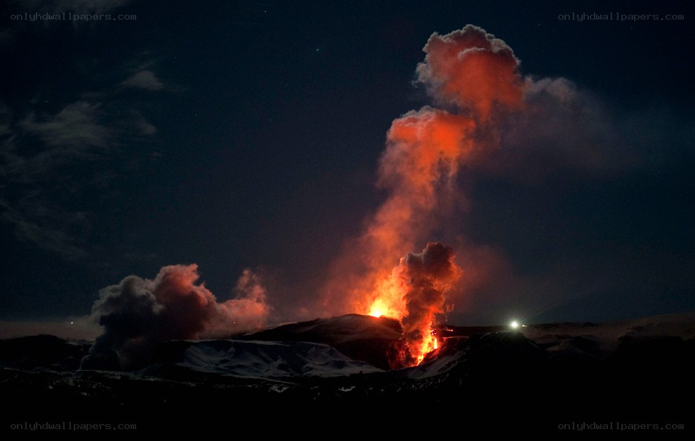 Volcano erupting at night