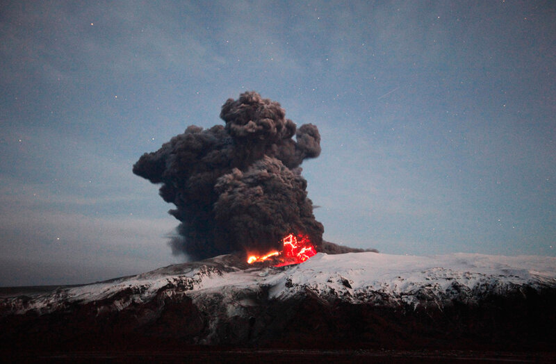 Volcano erupting at night