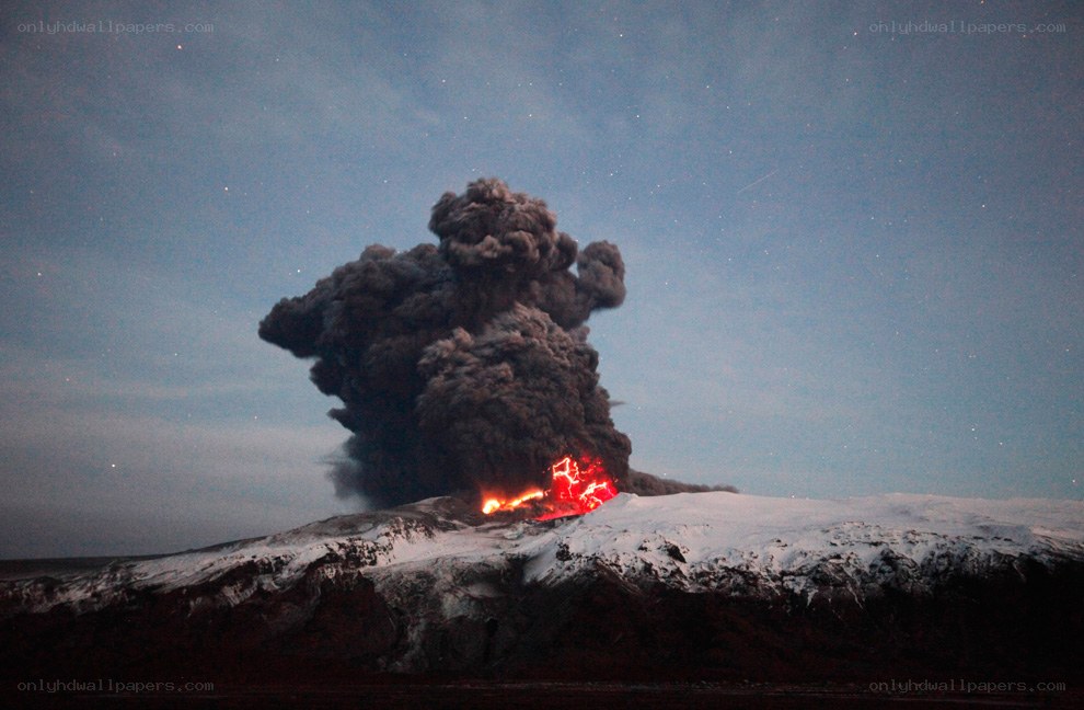 Volcano erupting at night