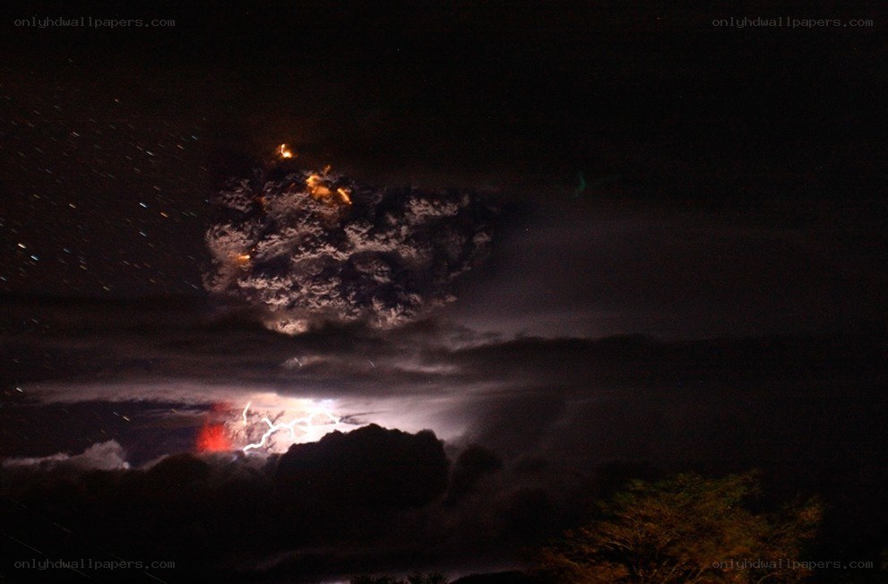 Volcano erupting at night