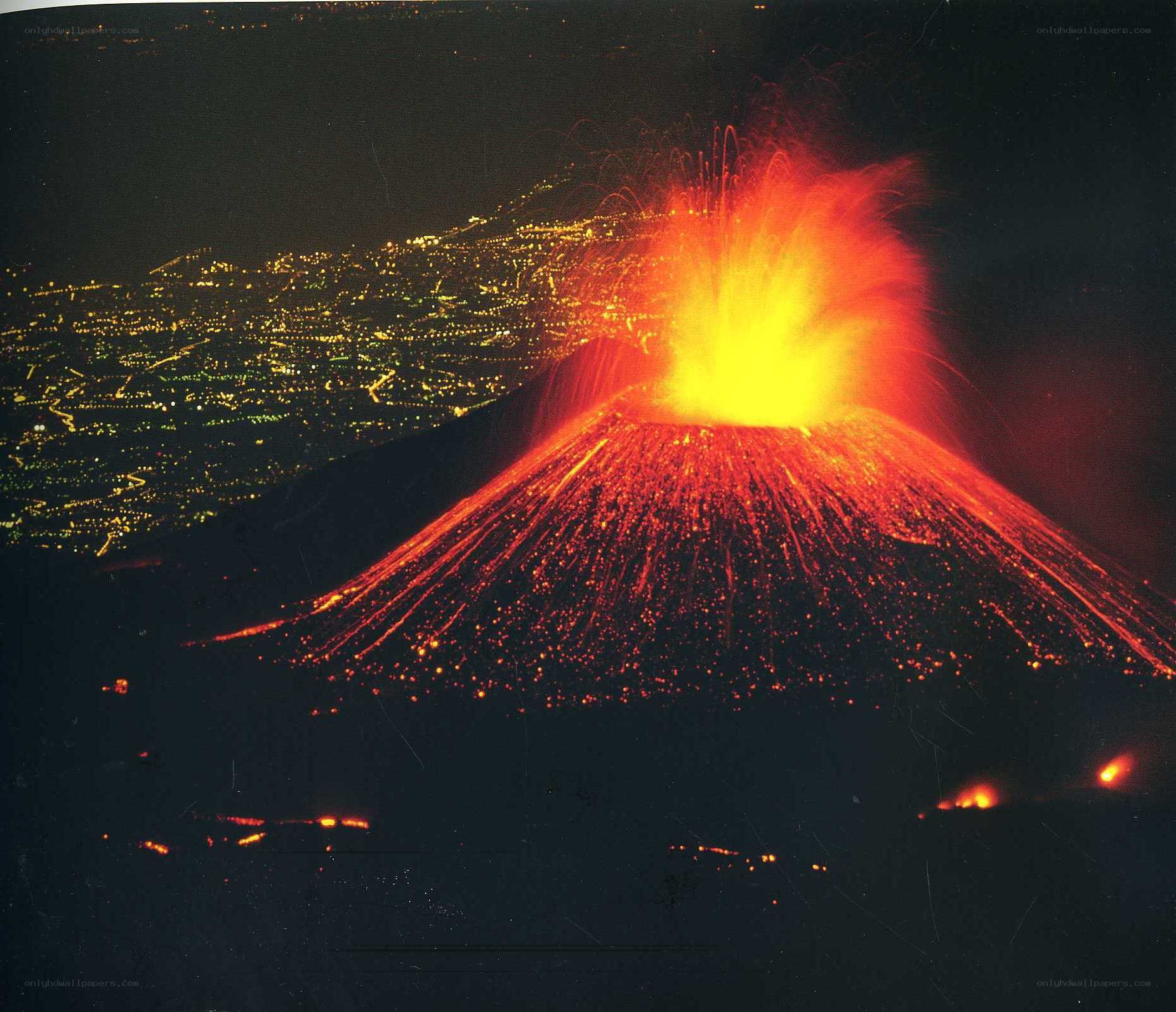 Volcano erupting at night