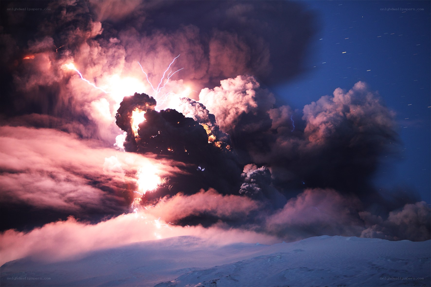 Volcano erupting at night