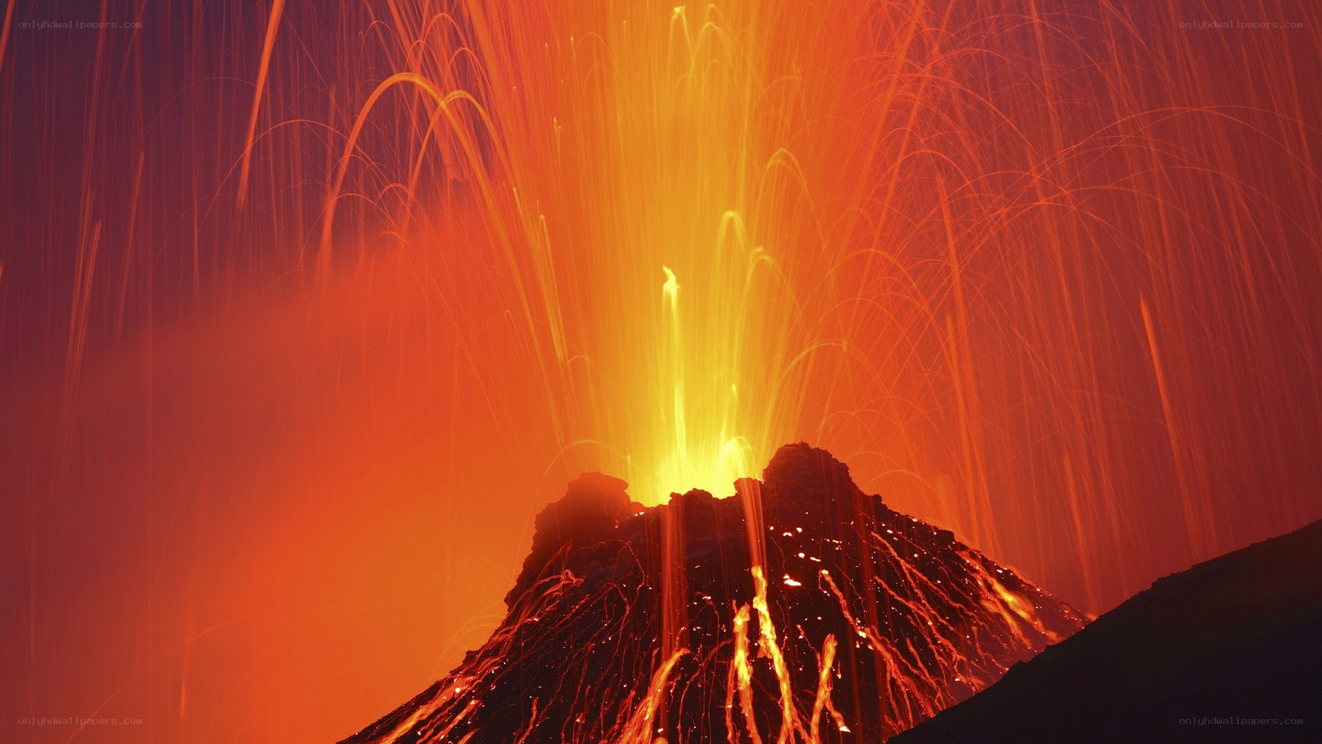 Volcano erupting at night