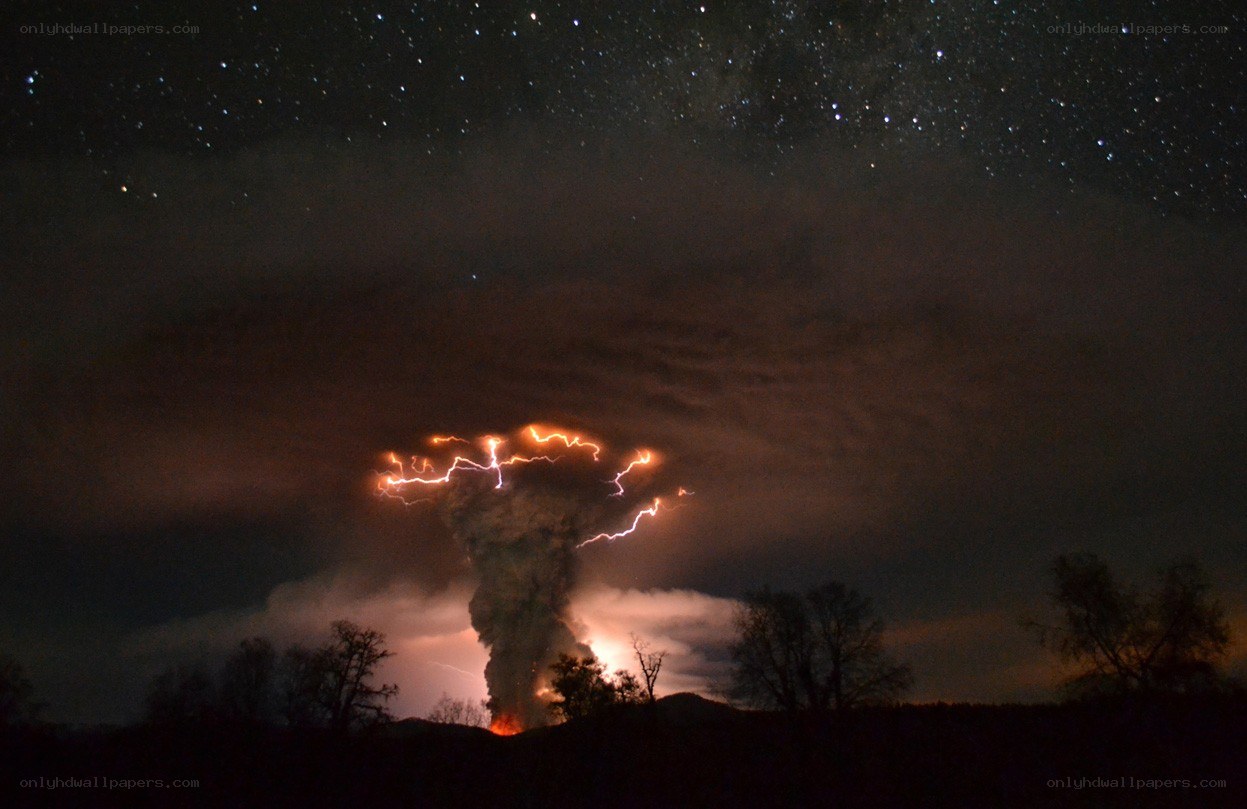 Volcano erupting at night
