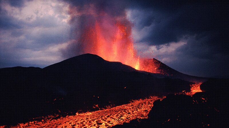 Volcano erupting at night