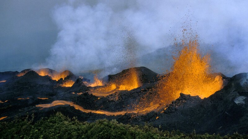 Volcano erupting at night