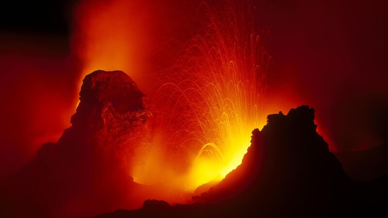 Volcano erupting at night