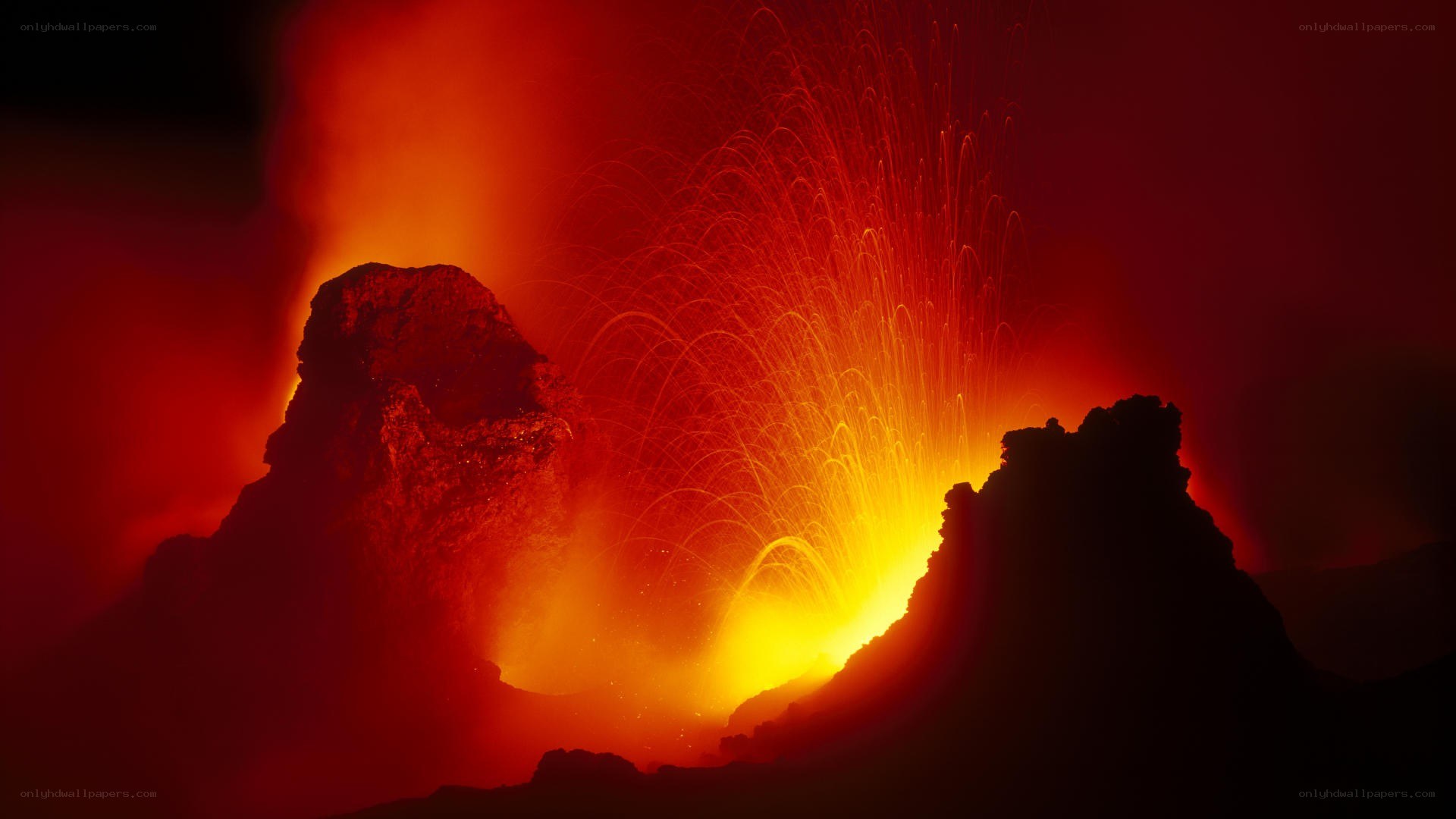 Volcano erupting at night