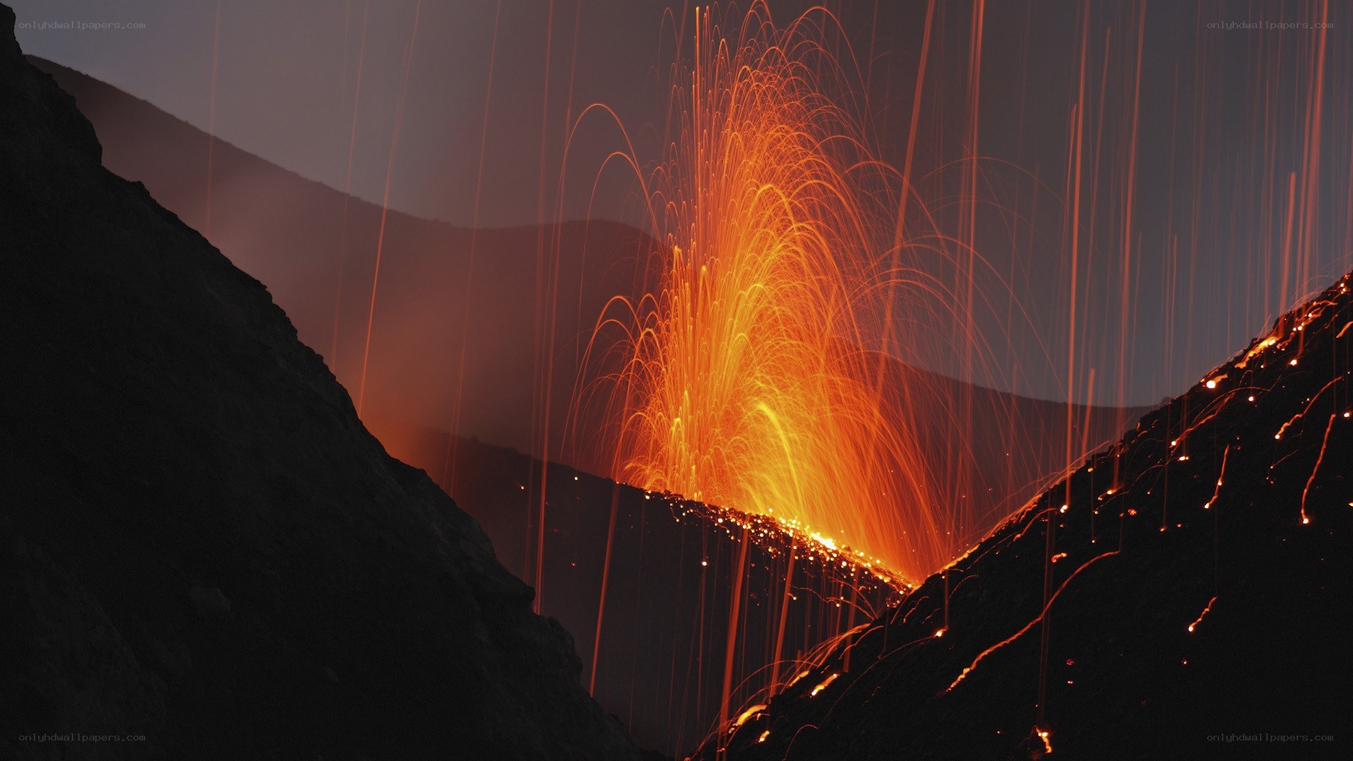 Volcano erupting at night