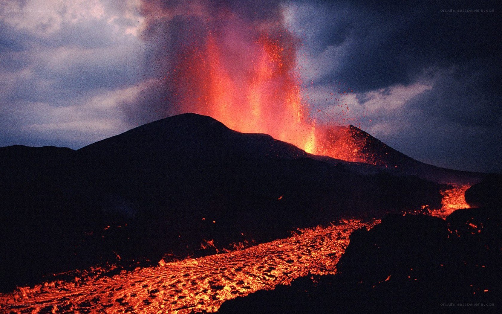 Volcano erupting at night