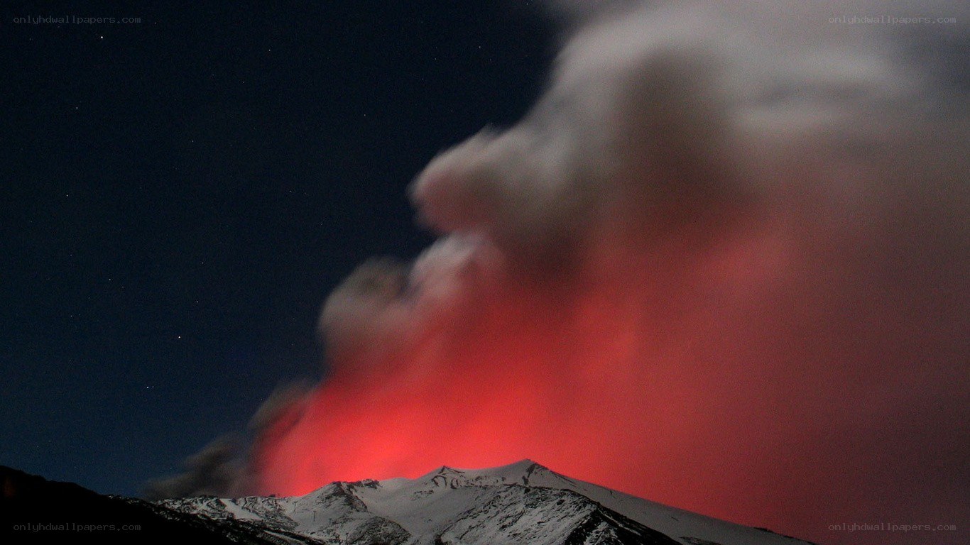 Volcano erupting at night