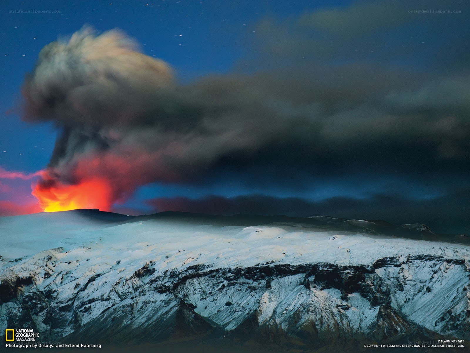 Volcano erupting at night