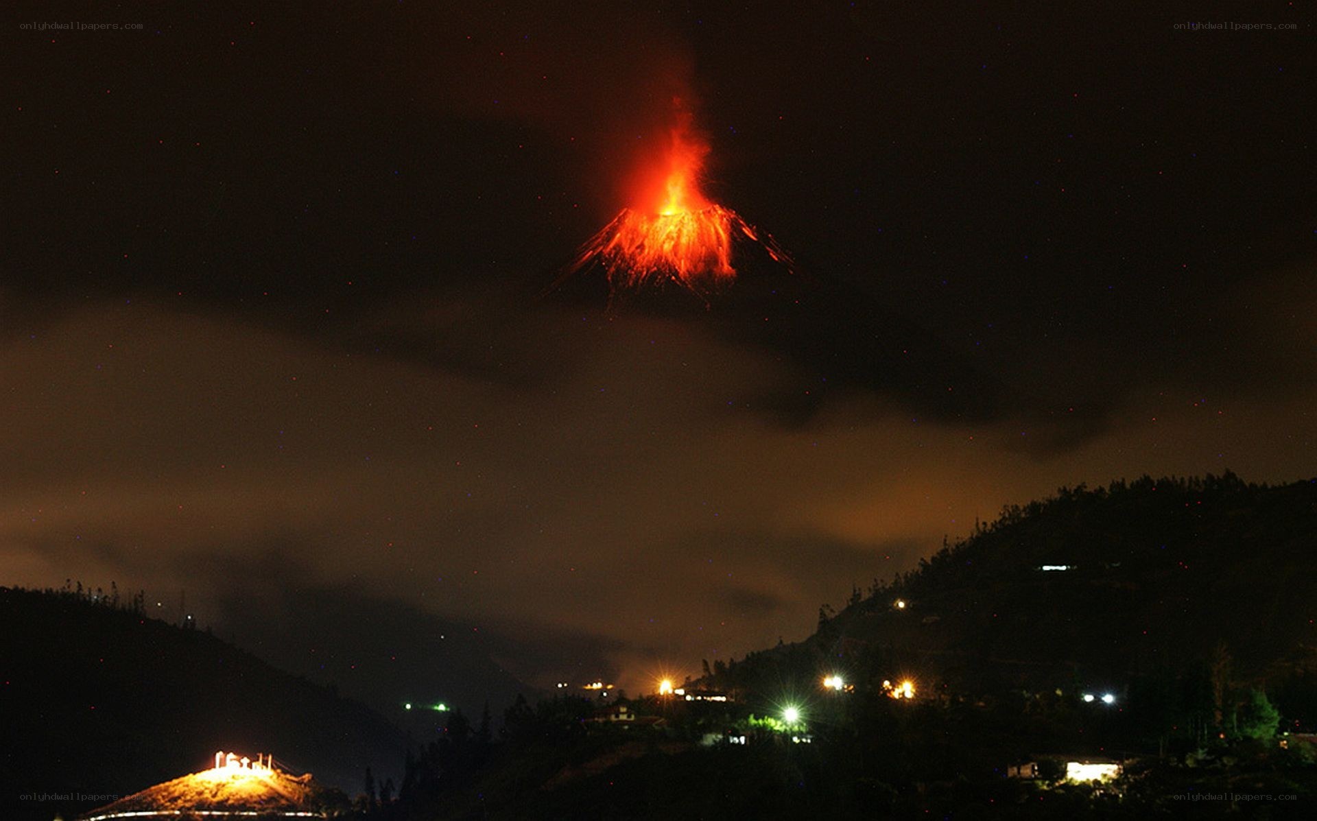Volcano erupting at night