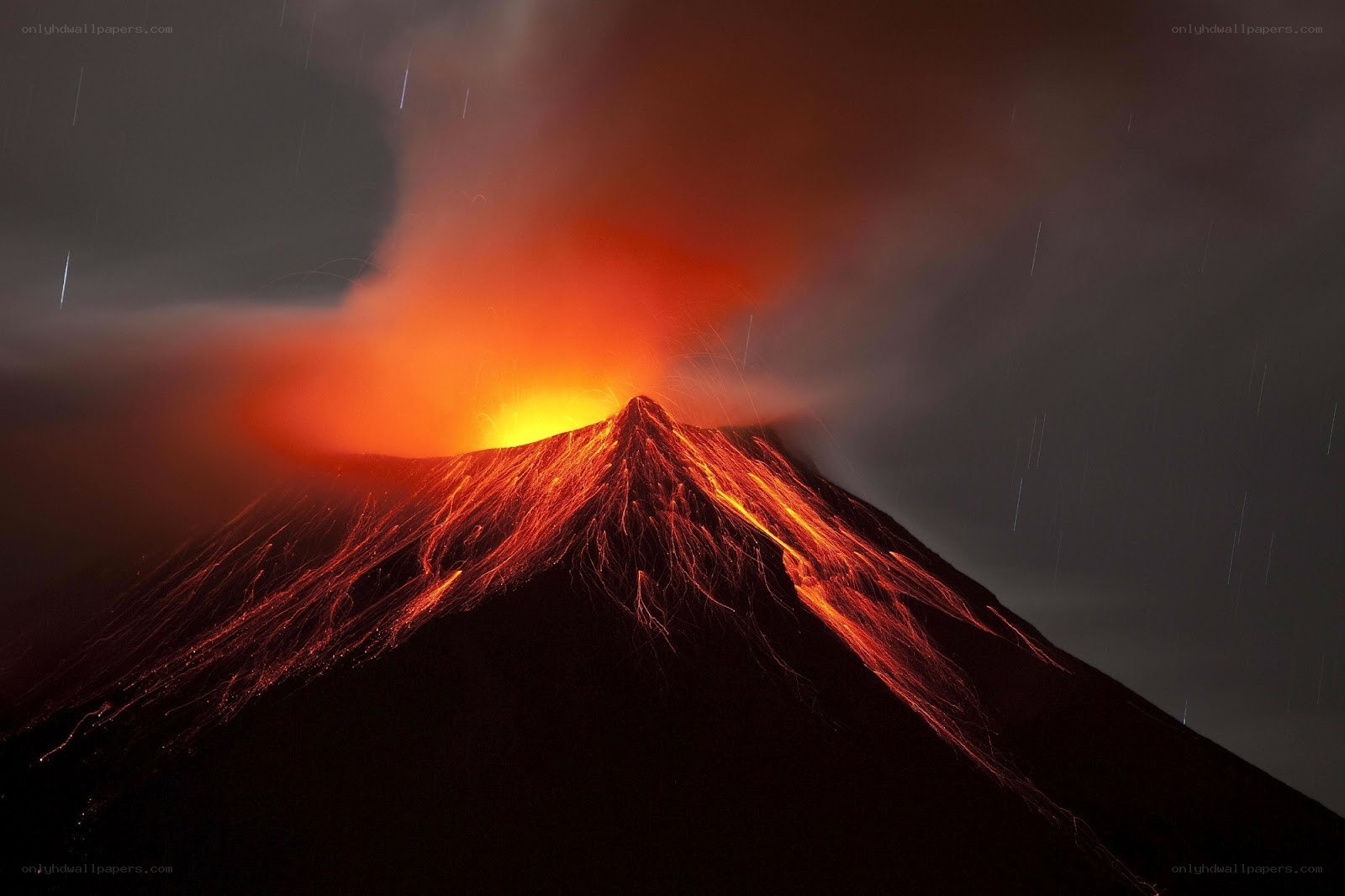 Volcano erupting at night
