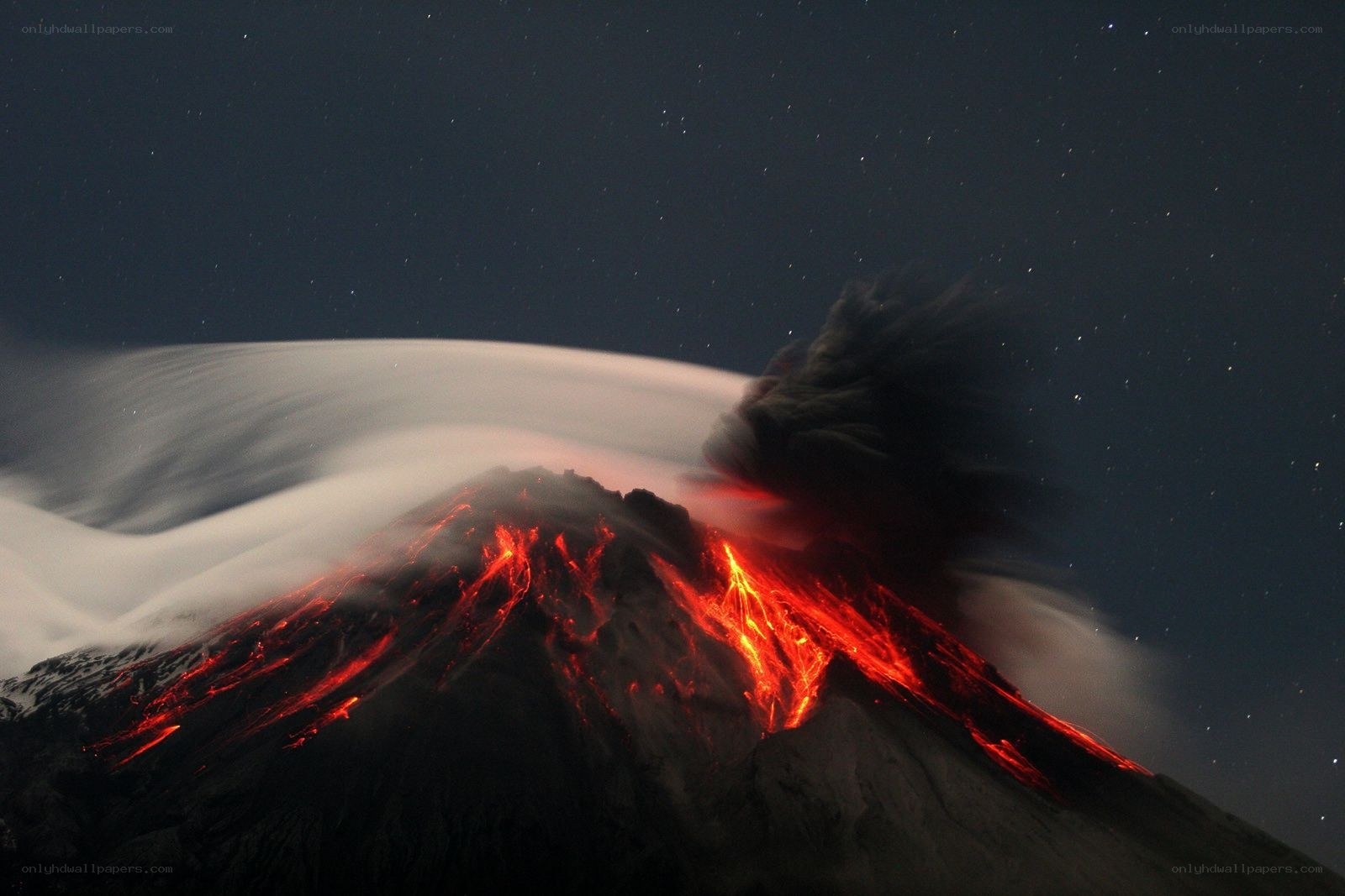 Volcano erupting at night