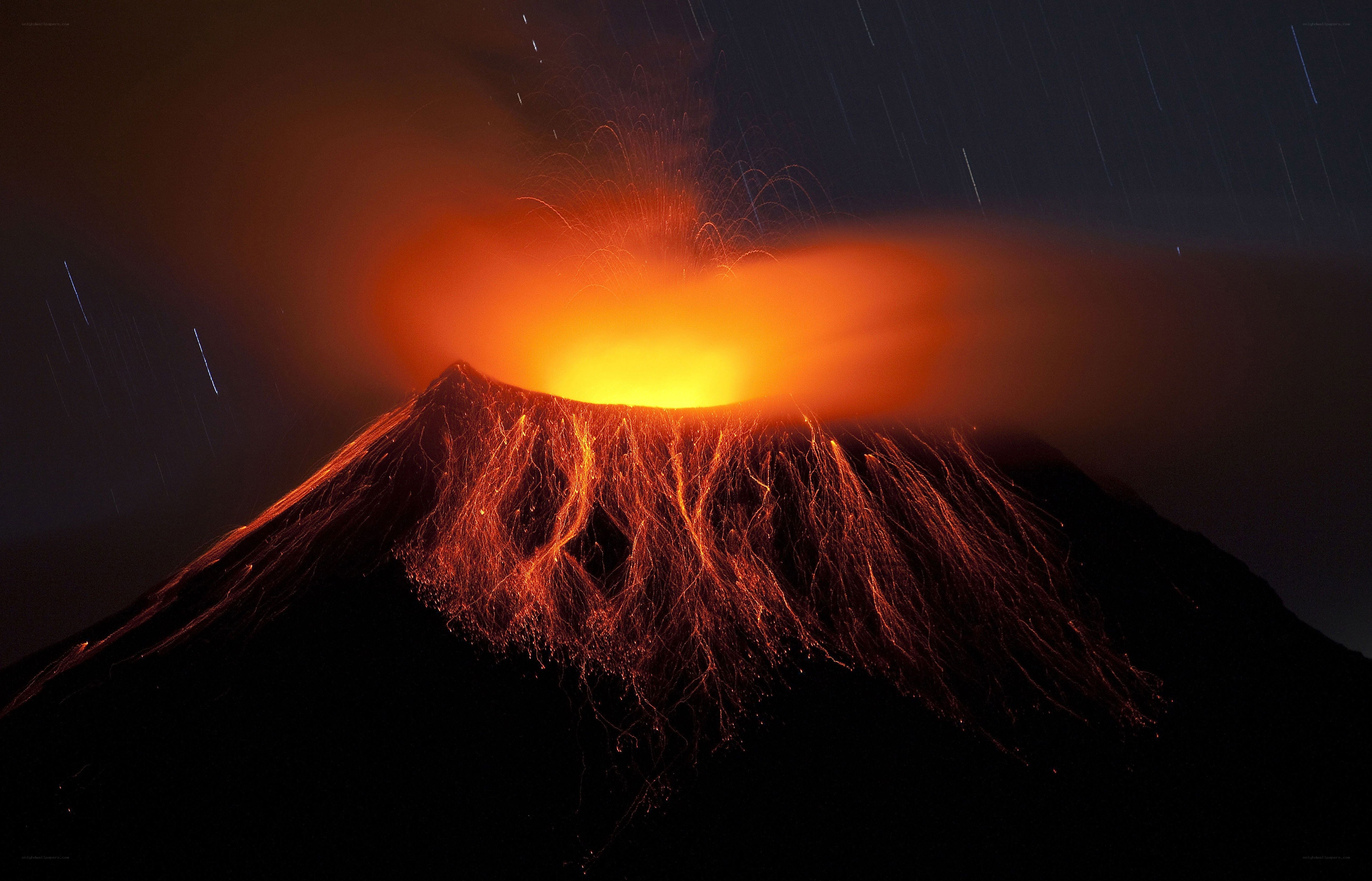 Volcano erupting at night