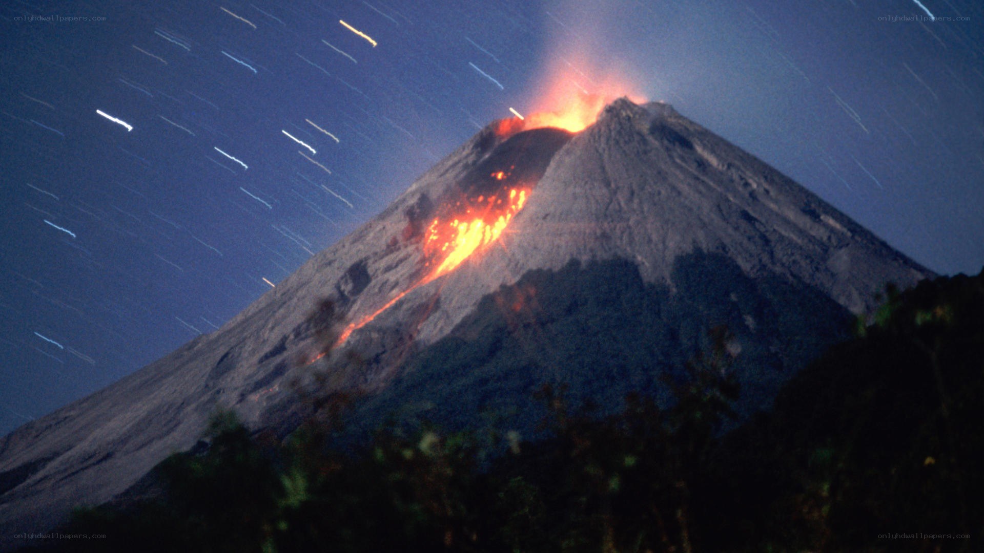 Volcano erupting at night