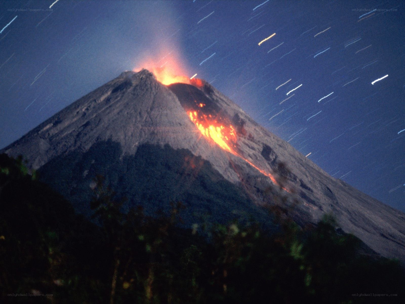 Volcano erupting at night