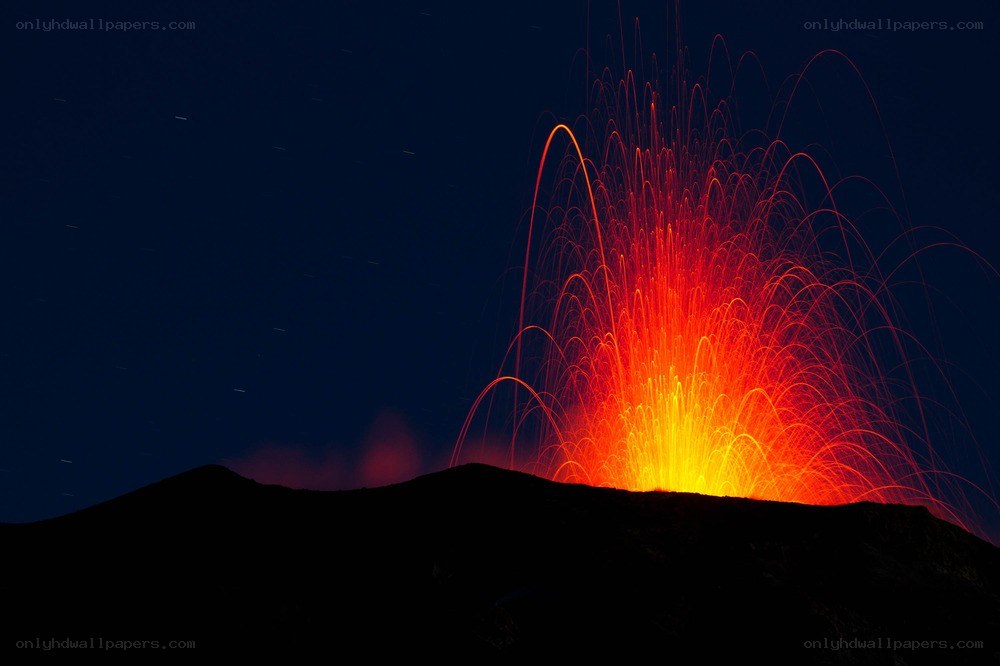 Volcano erupting at night