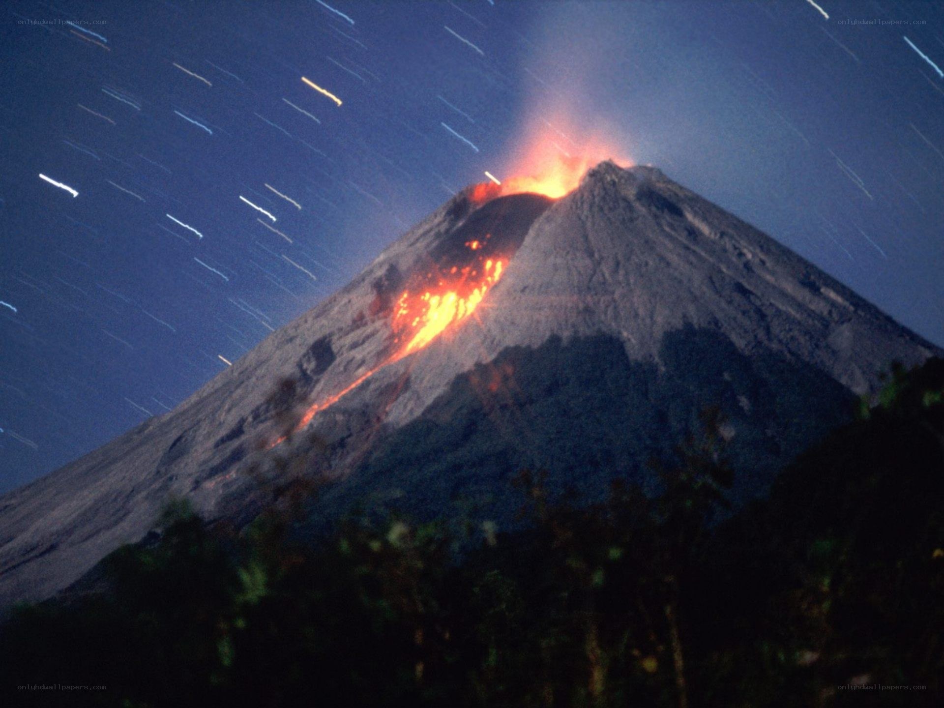 Volcano erupting at night