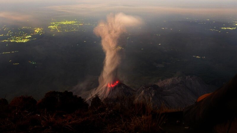 Volcano erupting at night