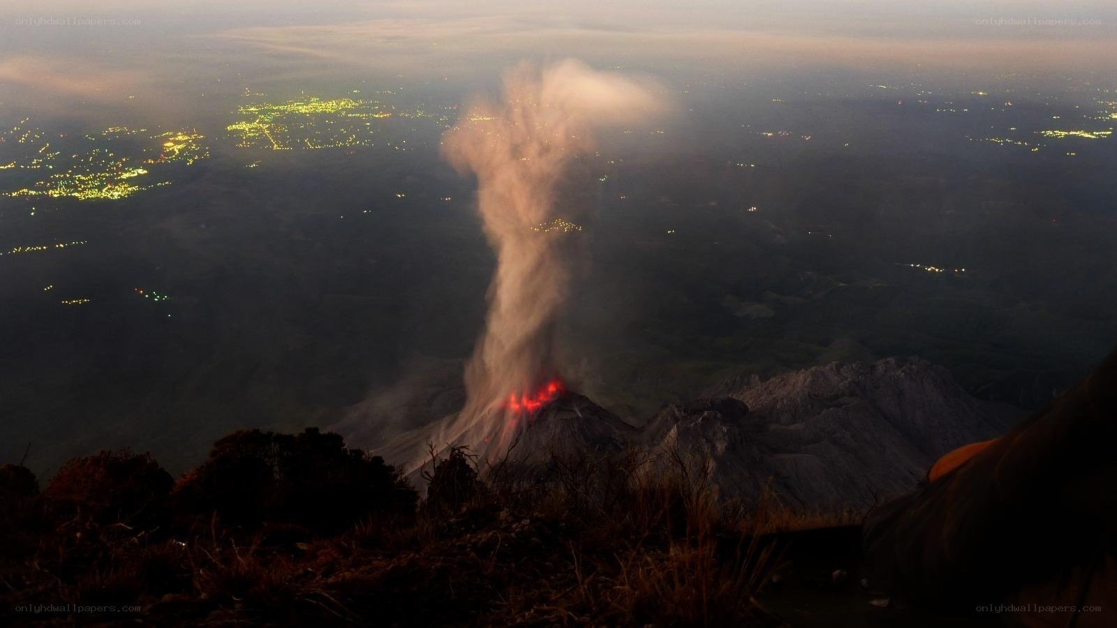 Volcano erupting at night
