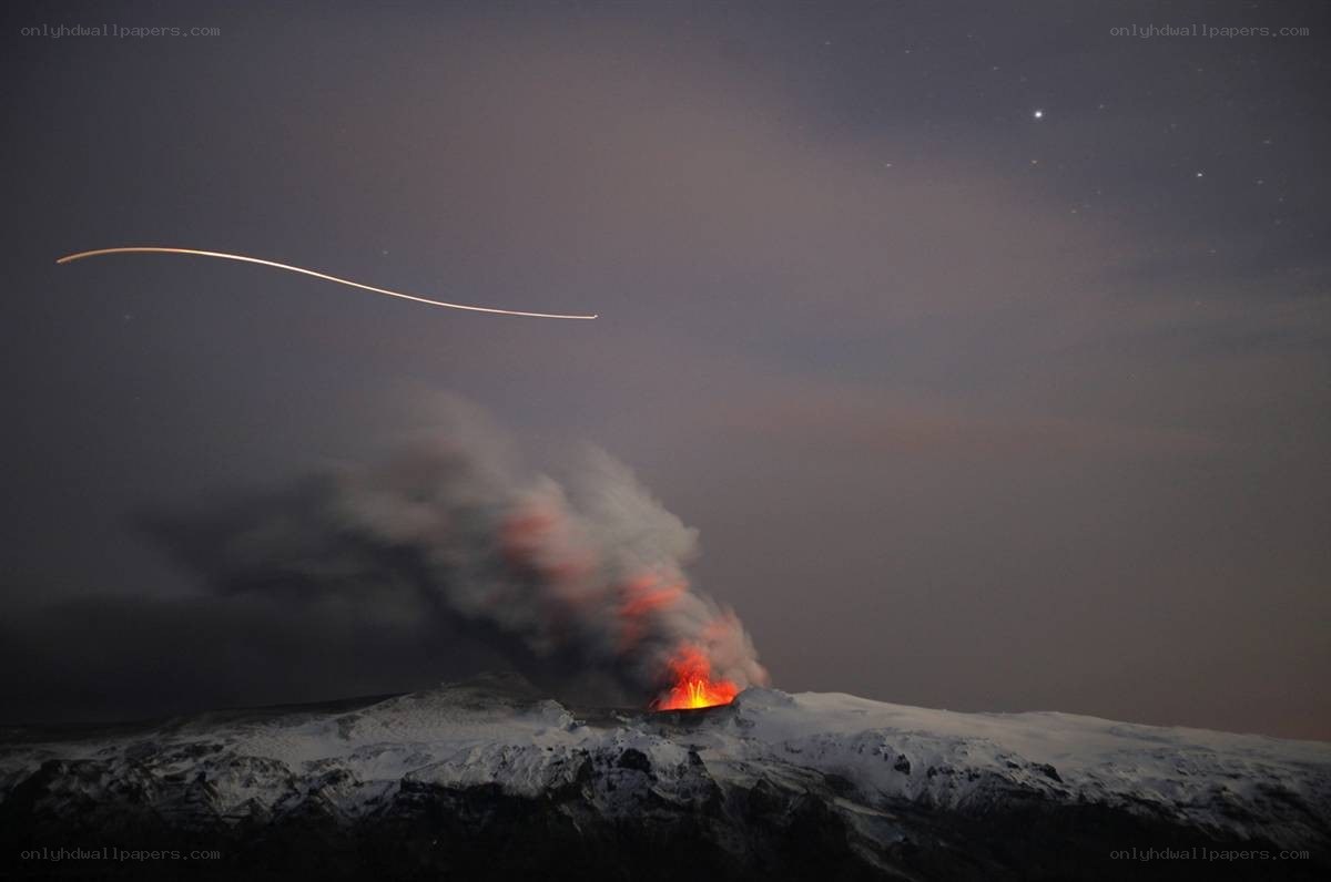 Volcano erupting at night