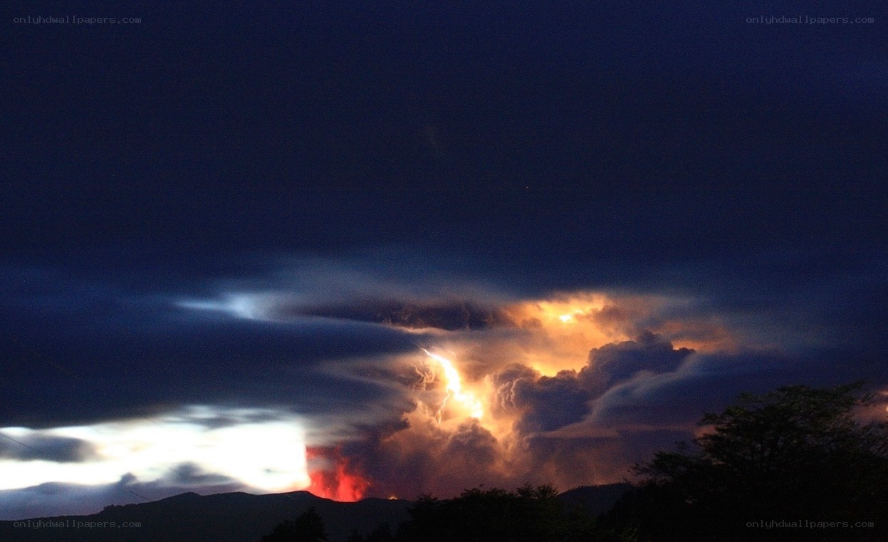 Volcano erupting at night