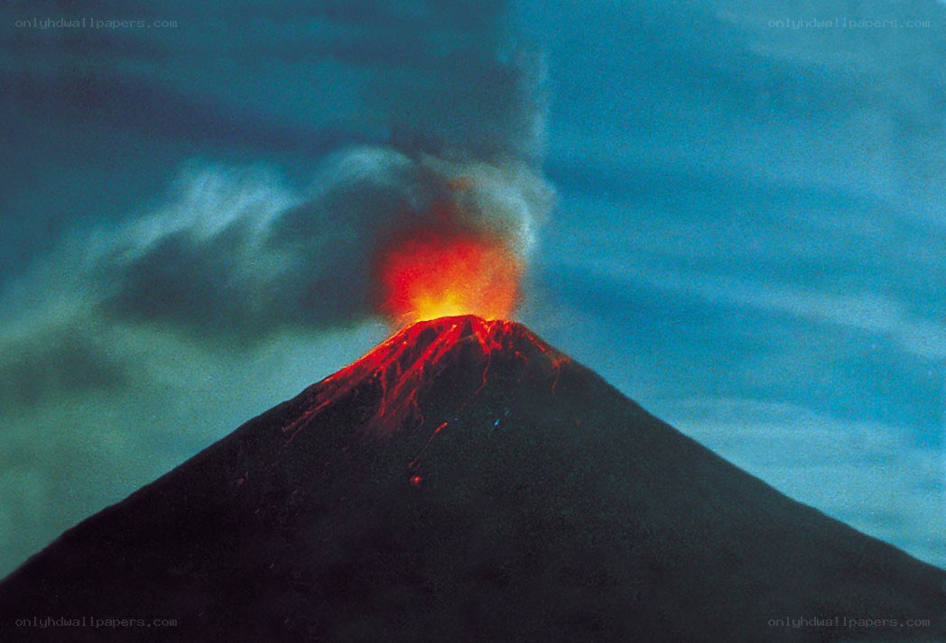 Volcano erupting at night