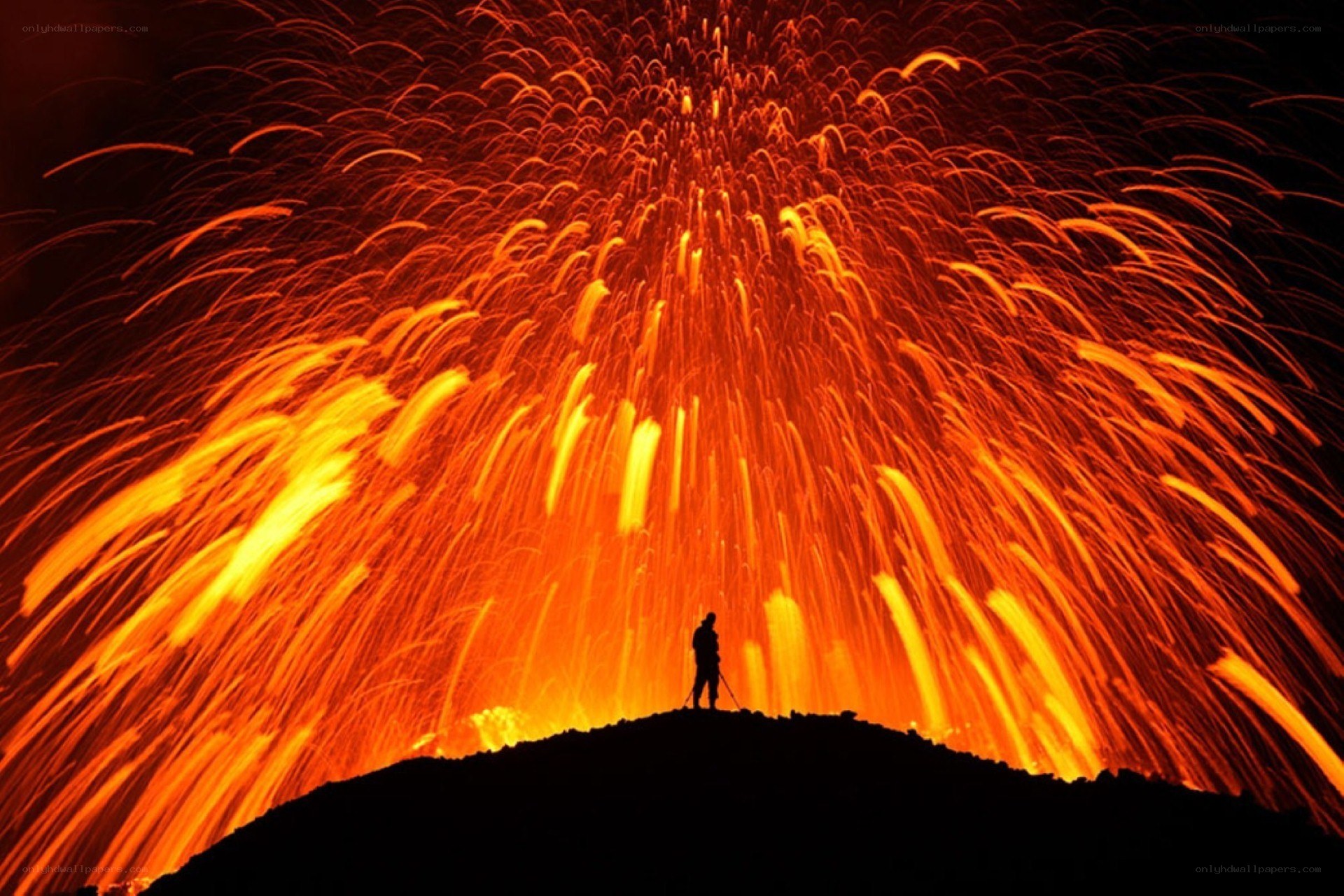 Volcano erupting at night