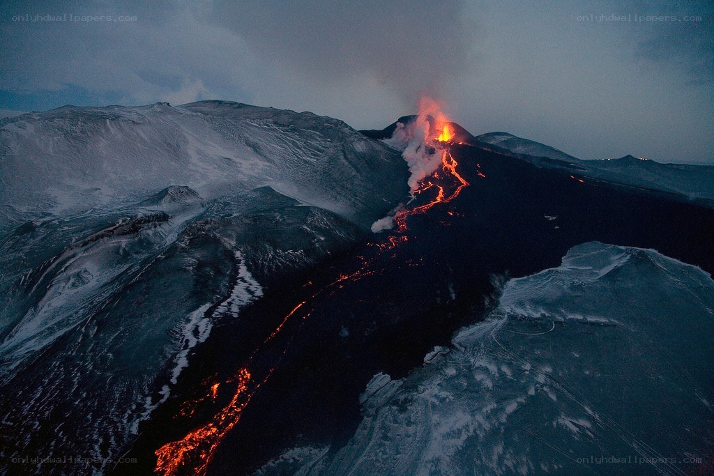 Volcano erupting at night