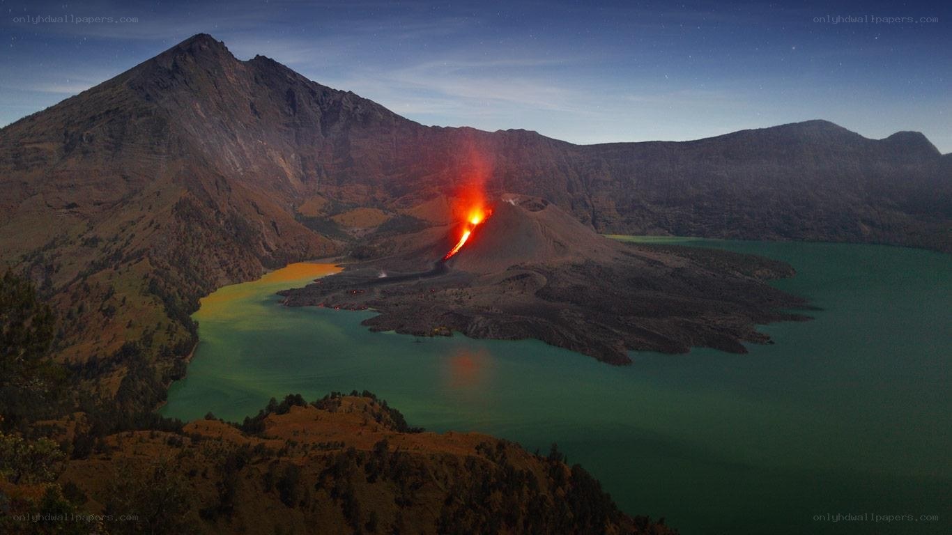 Volcano erupting at night