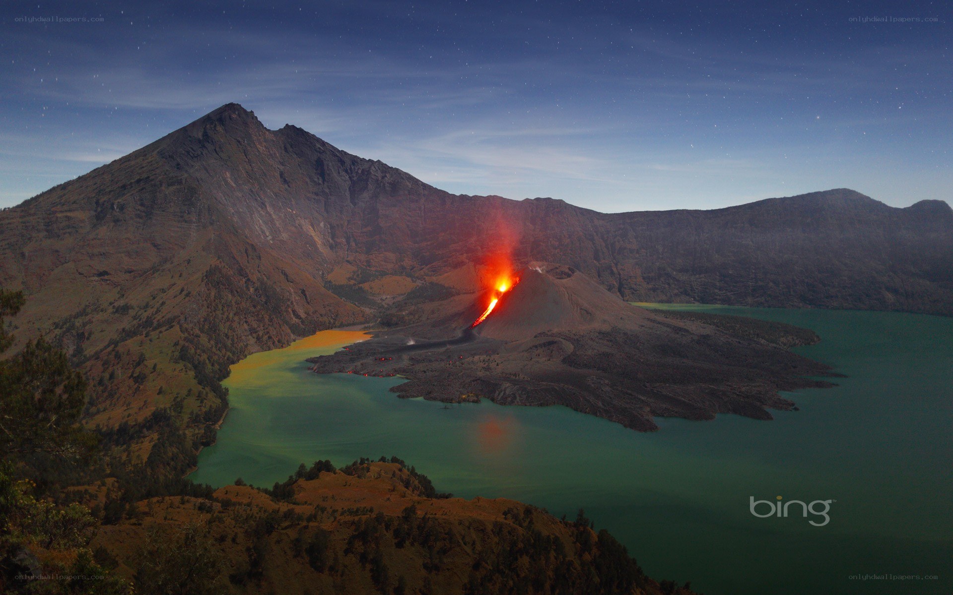 Volcano erupting at night