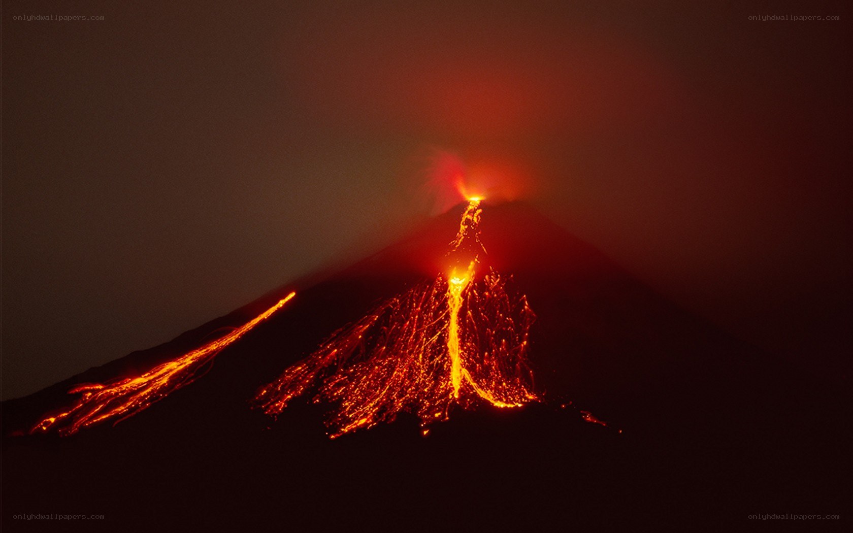 Volcano erupting at night